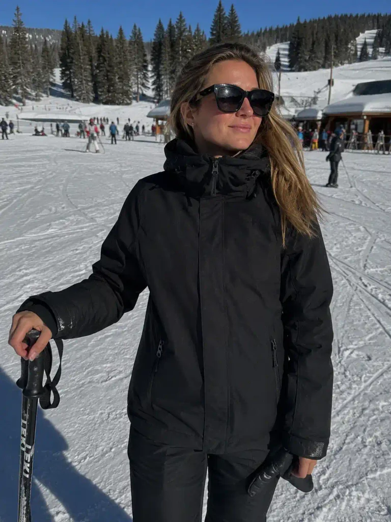 16. All-black outfit with statement sunglasses instead of goggles