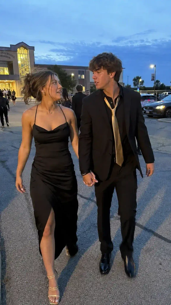 Black suit with a gold tie and matching gold heels