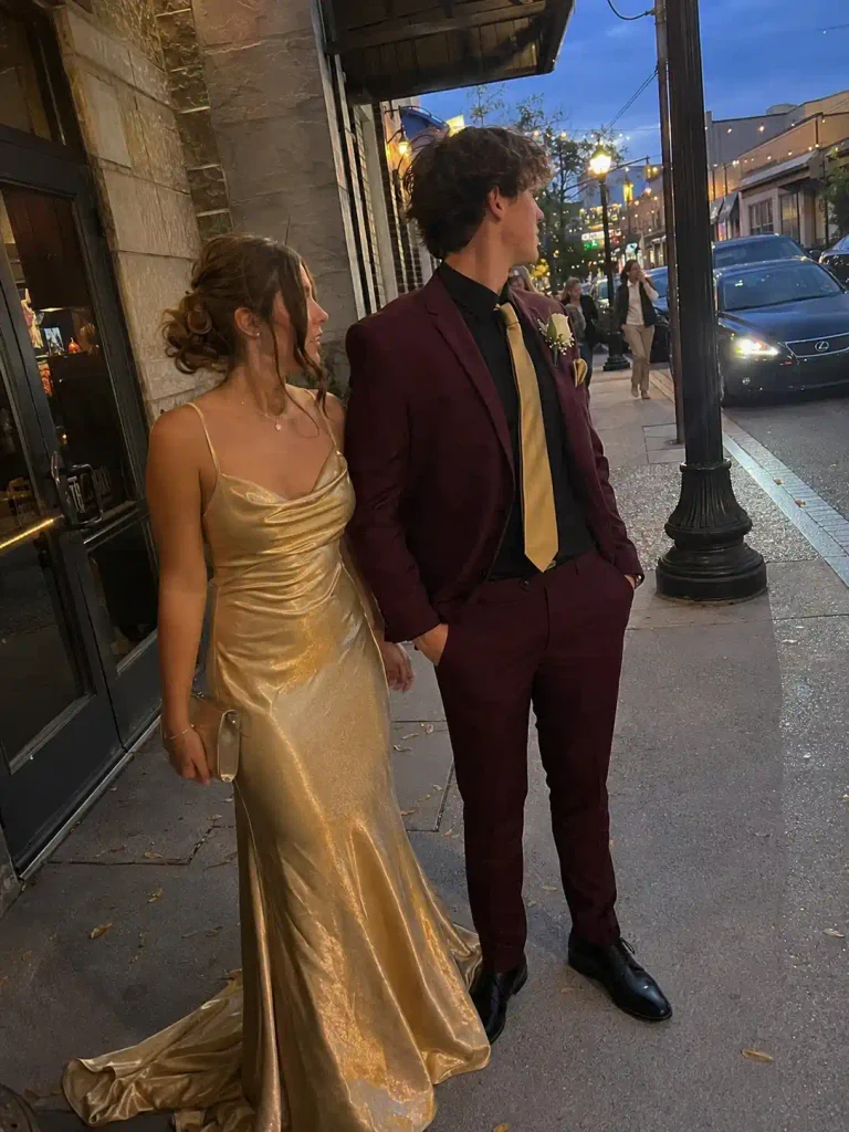 Gold gown with a burgundy suit and gold tie